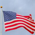 usa flag waving on white metal pole