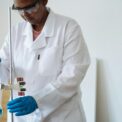 focused african american researcher conducting biochemical experiment in clinic