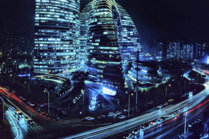 moving cars on the road near wangjing soho buildings